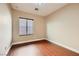 Comfortable bedroom featuring wood floors, natural light, and neutral decor at 5505 Criollo Dr, Las Vegas, NV 89122