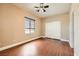 Bright bedroom features wood floors, ceiling fan, and window with natural light at 5505 Criollo Dr, Las Vegas, NV 89122