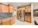 Contemporary kitchen featuring stainless steel appliances, wood cabinets and tiled backsplash at 5505 Criollo Dr, Las Vegas, NV 89122