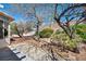Spacious backyard with desert landscaping and partially covered patio at 570 Cypress Gardens Pl, Henderson, NV 89012
