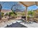 Backyard with mature trees, shade, garden, and partial patio cover at 570 Cypress Gardens Pl, Henderson, NV 89012
