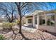 Spacious backyard with mature trees, landscaping, and direct access to the partially covered patio at 570 Cypress Gardens Pl, Henderson, NV 89012