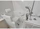 Luxurious bathroom features a pristine white walk-in tub with safety bars and handheld shower at 570 Cypress Gardens Pl, Henderson, NV 89012