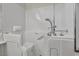 Spacious white bathroom features a walk-in tub with safety bars and shower head at 570 Cypress Gardens Pl, Henderson, NV 89012