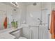 Bright bathroom with walk-in tub, plant decor, and a well-lit mirror over the vanity at 570 Cypress Gardens Pl, Henderson, NV 89012