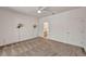 Cozy bedroom with neutral carpet, ceiling fan, and sconce lighting, leading to the bathroom at 570 Cypress Gardens Pl, Henderson, NV 89012