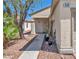 Inviting home entrance with decorative plants and desert landscaping features at 570 Cypress Gardens Pl, Henderson, NV 89012