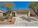 Charming single-story home with a well-manicured lawn and a two-car garage at 570 Cypress Gardens Pl, Henderson, NV 89012