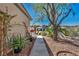 Sidewalk view of home with desert landscaping, plants, and a concrete walkway at 570 Cypress Gardens Pl, Henderson, NV 89012