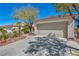 Attractive home featuring a spacious two-car garage and desert landscaping at 570 Cypress Gardens Pl, Henderson, NV 89012
