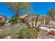 Well-maintained single-story home with desert landscaping and a charming bridge feature at 570 Cypress Gardens Pl, Henderson, NV 89012