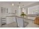 Well-lit kitchen showcasing a kitchen island, hanging lights, open shelves, and modern appliances at 570 Cypress Gardens Pl, Henderson, NV 89012