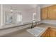 Bright kitchen featuring a kitchen island and a seamless view into the living area at 570 Cypress Gardens Pl, Henderson, NV 89012