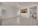 Open living space with tile floors, ceiling fan, and a view of the kitchen through a half wall at 570 Cypress Gardens Pl, Henderson, NV 89012