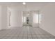 Bright and airy living room featuring tiled floors and a decorative light fixture near the front door at 570 Cypress Gardens Pl, Henderson, NV 89012