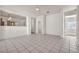 Spacious living area with tile flooring, ceiling fan, and a view of the adjacent rooms at 570 Cypress Gardens Pl, Henderson, NV 89012
