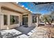 Covered patio with tile flooring, mature landscaping, and direct access to the backyard at 570 Cypress Gardens Pl, Henderson, NV 89012