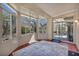 Enclosed sunroom featuring multiple windows and a sliding glass door to the outside area at 570 Cypress Gardens Pl, Henderson, NV 89012