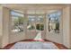 Inviting sunroom with lots of windows overlooking a serene garden and yard at 570 Cypress Gardens Pl, Henderson, NV 89012