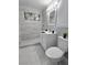 Modern bathroom featuring a tiled shower, white vanity, and sleek fixtures, complemented by marble flooring at 620 N 16Th St, Las Vegas, NV 89101