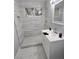 Modern bathroom featuring a tiled shower, white vanity, and sleek fixtures, complemented by marble flooring at 620 N 16Th St, Las Vegas, NV 89101