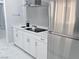 Modern kitchen featuring white cabinets, stainless steel appliances, and a cooktop range at 620 N 16Th St, Las Vegas, NV 89101