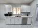 Well-lit kitchen featuring updated stainless appliances and sleek white cabinetry at 620 N 16Th St, Las Vegas, NV 89101