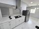 Bright kitchen with stainless steel appliances, white cabinets, and modern range hood at 620 N 16Th St, Las Vegas, NV 89101