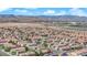 Extensive aerial view of a vibrant residential area against a backdrop of mountains and industrial areas at 6217 Lone Cypress Ct, Las Vegas, NV 89141