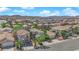 Expansive aerial view of a well-planned community featuring diverse homes, lush landscaping, and desert mountain backdrop at 6217 Lone Cypress Ct, Las Vegas, NV 89141