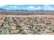 Wide aerial shot of a neatly planned community, highlighting mountain views, consistent architecture, and desert landscape at 6217 Lone Cypress Ct, Las Vegas, NV 89141