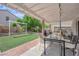 Relaxing backyard with covered patio, perfect for entertaining, and faux grass lawn at 6217 Lone Cypress Ct, Las Vegas, NV 89141
