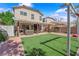 Well maintained backyard and patio including both brick and artificial turf at 6217 Lone Cypress Ct, Las Vegas, NV 89141
