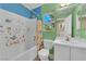 Colorful bathroom with tub-shower combo and playful ocean-themed decor at 6217 Lone Cypress Ct, Las Vegas, NV 89141