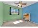 Bright bedroom with two-tone walls, modern ceiling fan, and a large window at 6217 Lone Cypress Ct, Las Vegas, NV 89141