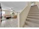 Open living area showing tile flooring, cozy seating, and a staircase leading to the upper level at 6217 Lone Cypress Ct, Las Vegas, NV 89141