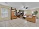 Spacious living room features tile floors, comfortable sofas, and built-in shelves with entertainment options at 6217 Lone Cypress Ct, Las Vegas, NV 89141