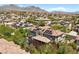 A high angle showcases the community of homes with private pools and solar panels on many roofs at 631 Coriander Canyon Ct, Las Vegas, NV 89138