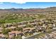 A community view showcases a large green space and houses with terracotta roofs, solar panels, and mountain views at 631 Coriander Canyon Ct, Las Vegas, NV 89138