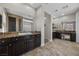 Bathroom featuring dual vanities, granite countertops, and sleek mirrors at 631 Coriander Canyon Ct, Las Vegas, NV 89138