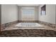 Luxurious soaking tub surrounded by mosaic tile, offering a relaxing retreat at 631 Coriander Canyon Ct, Las Vegas, NV 89138
