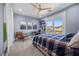 Well-lit bedroom with balcony, wall art, and a comfortable seating area at 631 Coriander Canyon Ct, Las Vegas, NV 89138