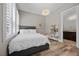 Cozy bedroom with a plush bed, hardwood floors, and natural light at 631 Coriander Canyon Ct, Las Vegas, NV 89138