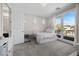 Bright bedroom with a balcony, cozy bed, and ensuite bathroom at 631 Coriander Canyon Ct, Las Vegas, NV 89138