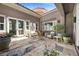 Charming courtyard featuring stone flooring, potted plants, and comfortable seating, perfect for relaxing outdoors at 631 Coriander Canyon Ct, Las Vegas, NV 89138
