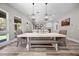 Elegant dining room with hardwood floors, modern lighting, and a view of the outdoors at 631 Coriander Canyon Ct, Las Vegas, NV 89138