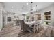 Open-concept dining area with hardwood floors and a view of the modern kitchen at 631 Coriander Canyon Ct, Las Vegas, NV 89138