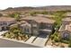 Beautiful two-story home with mature trees, a three-car garage, and mountain views at 631 Coriander Canyon Ct, Las Vegas, NV 89138