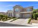 Charming home with well-kept yard and a two-car garage with stone accents at 631 Coriander Canyon Ct, Las Vegas, NV 89138
