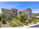 Beautiful two-story home with landscaped front yard, stone accents, and a two-car garage at 631 Coriander Canyon Ct, Las Vegas, NV 89138